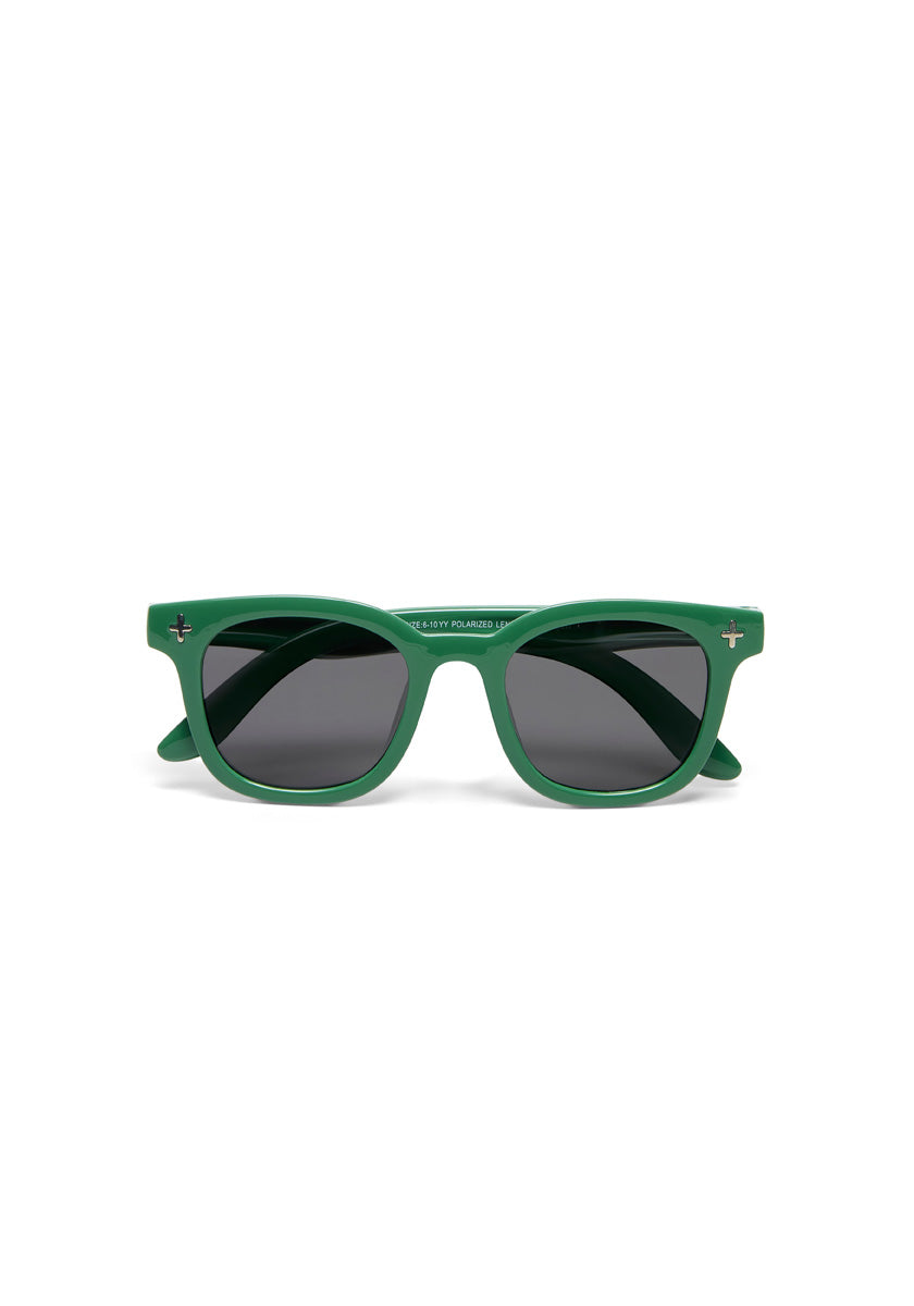 A pair of Okkia Kinder-Sonnenbrille with thick matte green TPEE wayfarer frames, dark tinted lenses, and small silver cross-shaped accents at the upper corners. Shown on a plain white background.