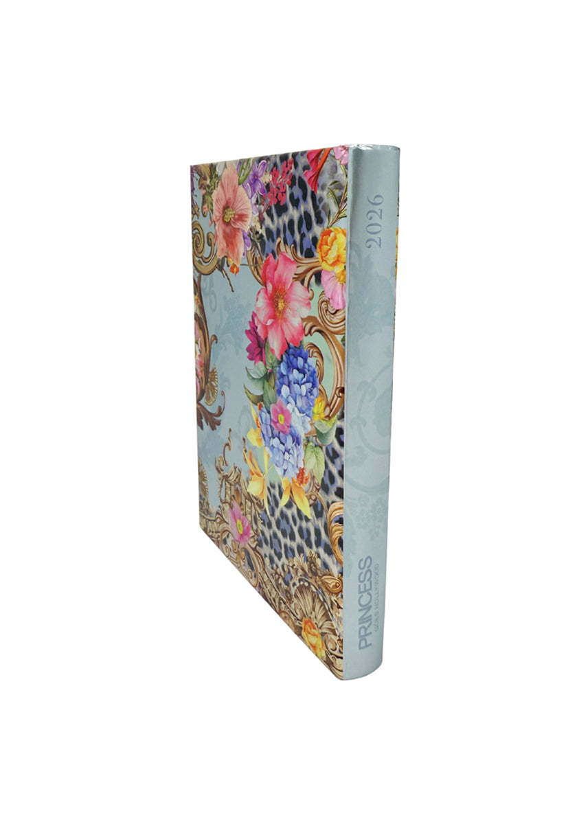 A vibrant hardcover Jahresplaner 2026 by Princess Goes Hollywood features a floral and leopard print with gold accents. Its light blue spine shows “2026” vertically and “PRINCESS” at the bottom. The planner stands against a white background.