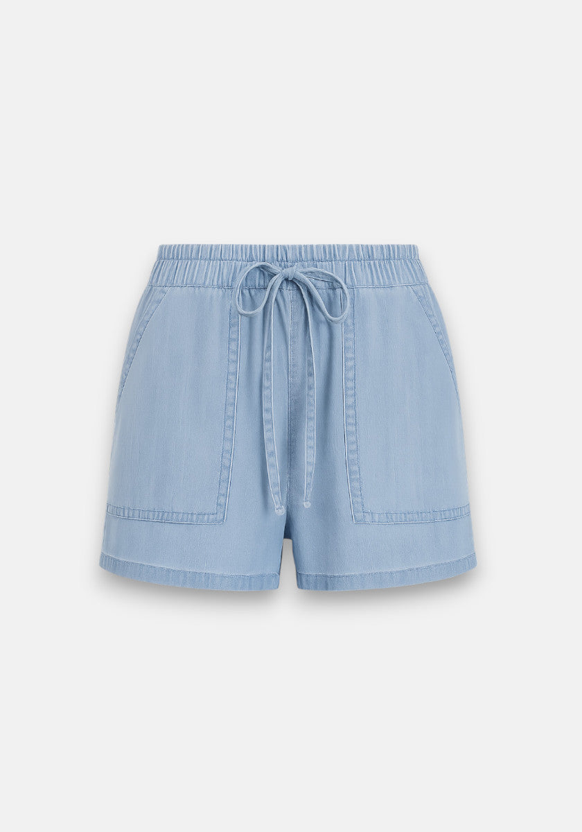 Bella Dahl light blue denim shorts with an elastic waistband, front drawstring, and two large pockets. Features visible seam stitching and a relaxed fit, shown against a plain white background.