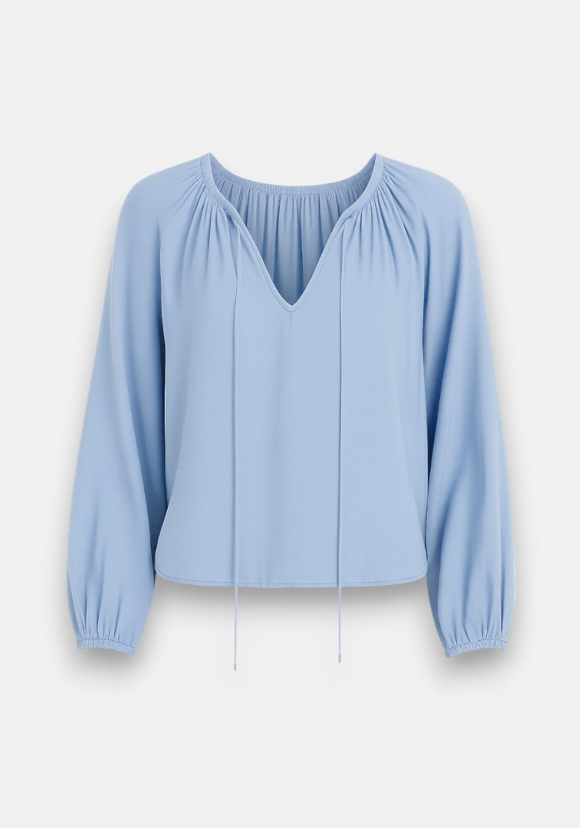 Bella Dahls light blue long-sleeve Lyocell blouse features a loose fit, gathered round neckline with drawstrings, and softly puffed balloon sleeves with elastic cuffs for a flowy silhouette.
