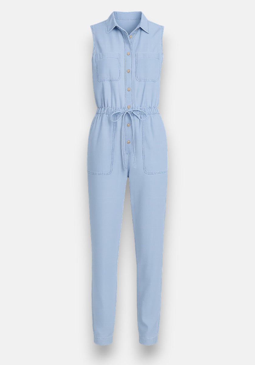 Bella Dahl sleeveless light blue jumpsuit in denim look with collared neckline, button-down front, two chest pockets, drawstring waist, and side pockets. Made from soft Lyocell with tapered full-length pants for a modern style.