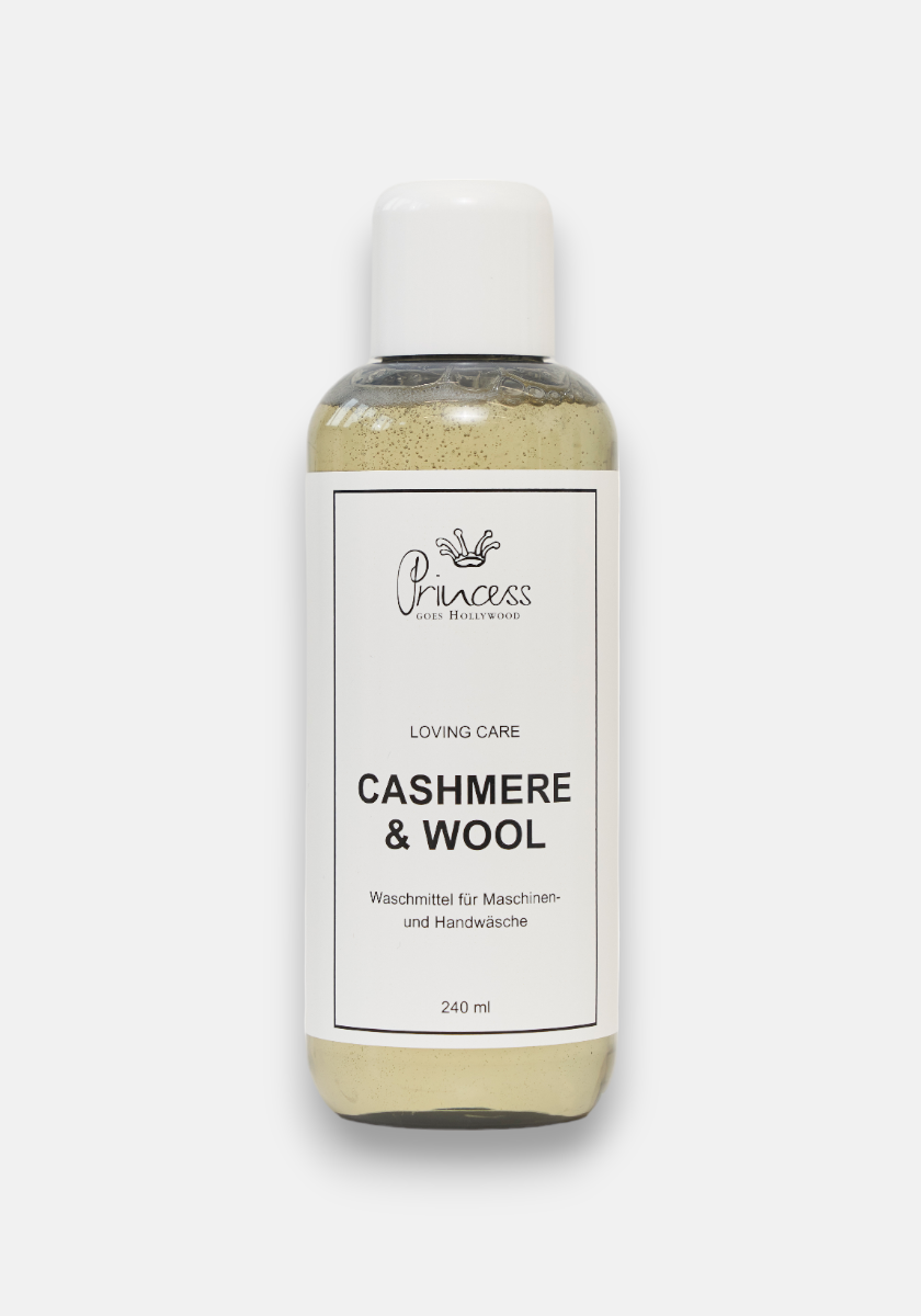 A clear plastic bottle with a white cap contains 240 ml of Princess Goes Hollywood Kaschmir &amp; Wolle Pflegewaschmittel for machine and hand washing; its beige wool detergent label features English and German text against a white background.